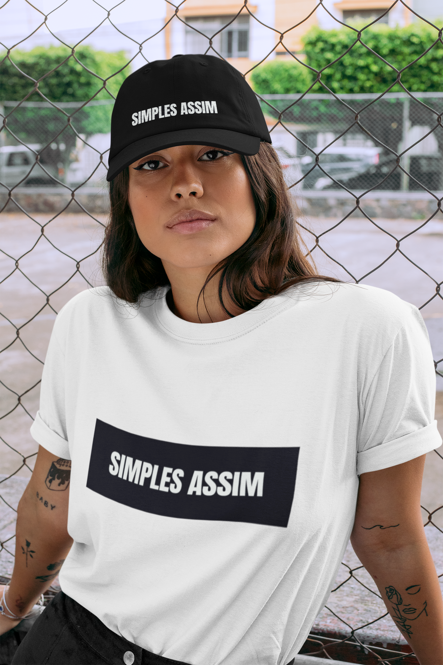 t-shirt-mockup-featuring-a-woman-wearing-a-dad-hat-by-a-chain-link-fence-28600 (1)